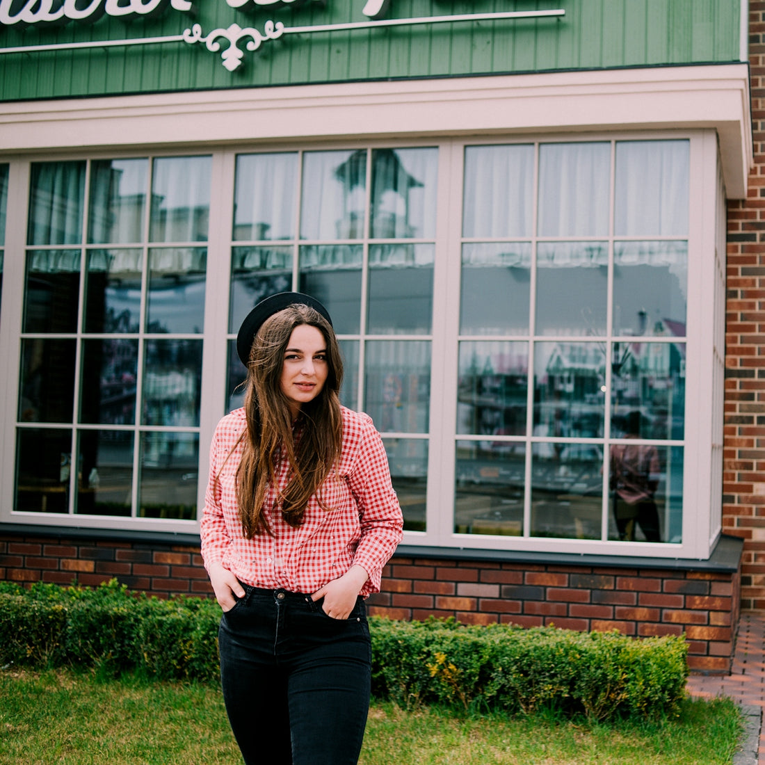 a woman standing in front of a building