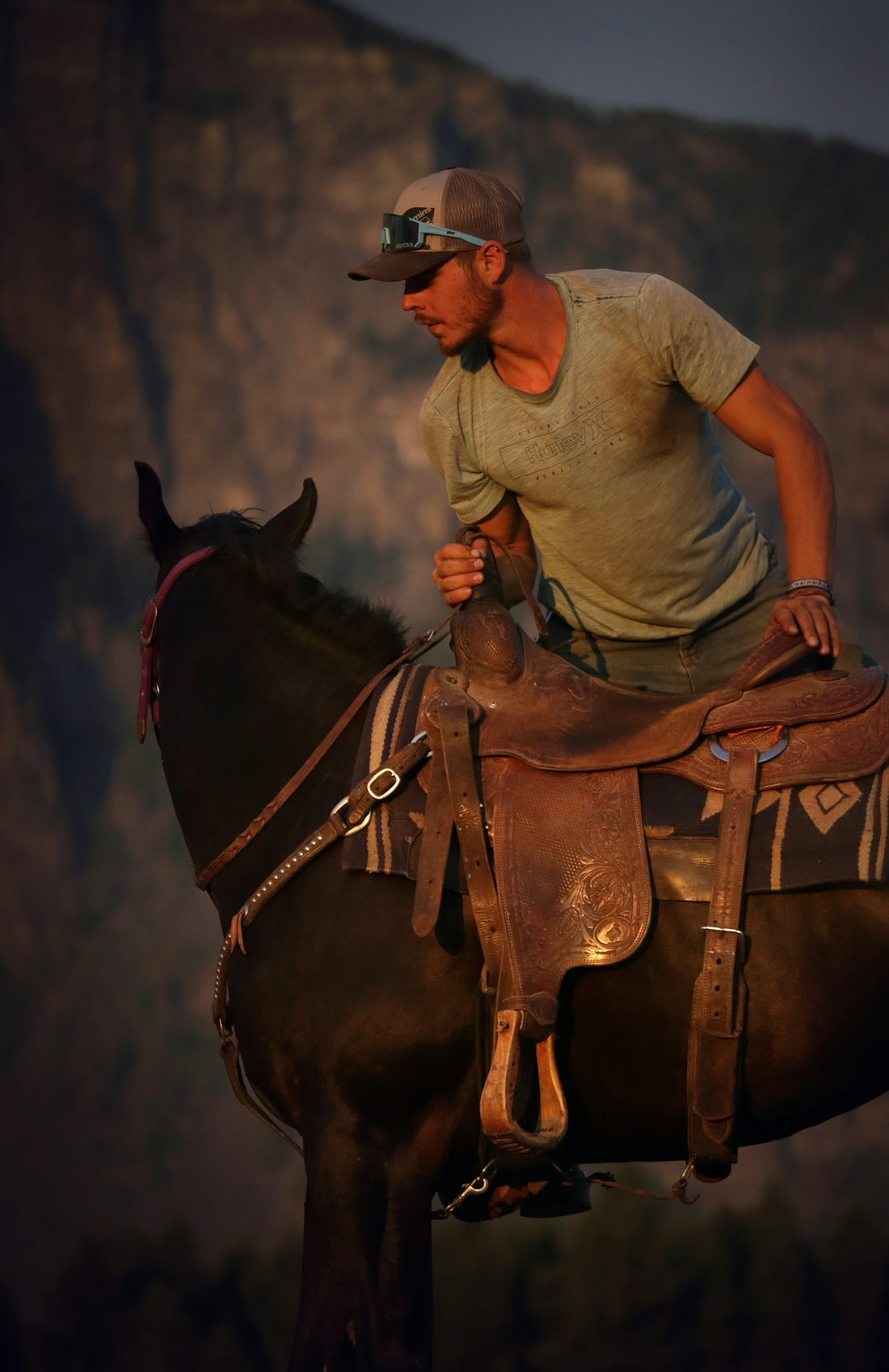 A man riding on the back of a brown horse
