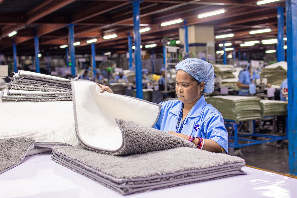 Woman working in a textile factory inspecting products.