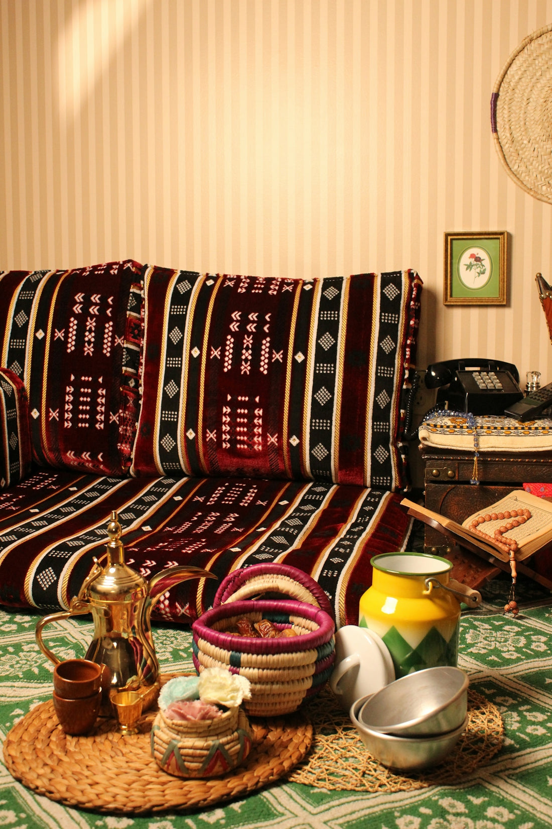 Traditional seating area with woven baskets and arabic coffee pot.