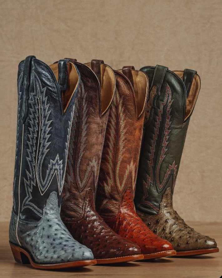 Four pairs of embroidered western boots in black, brown, rust, and olive