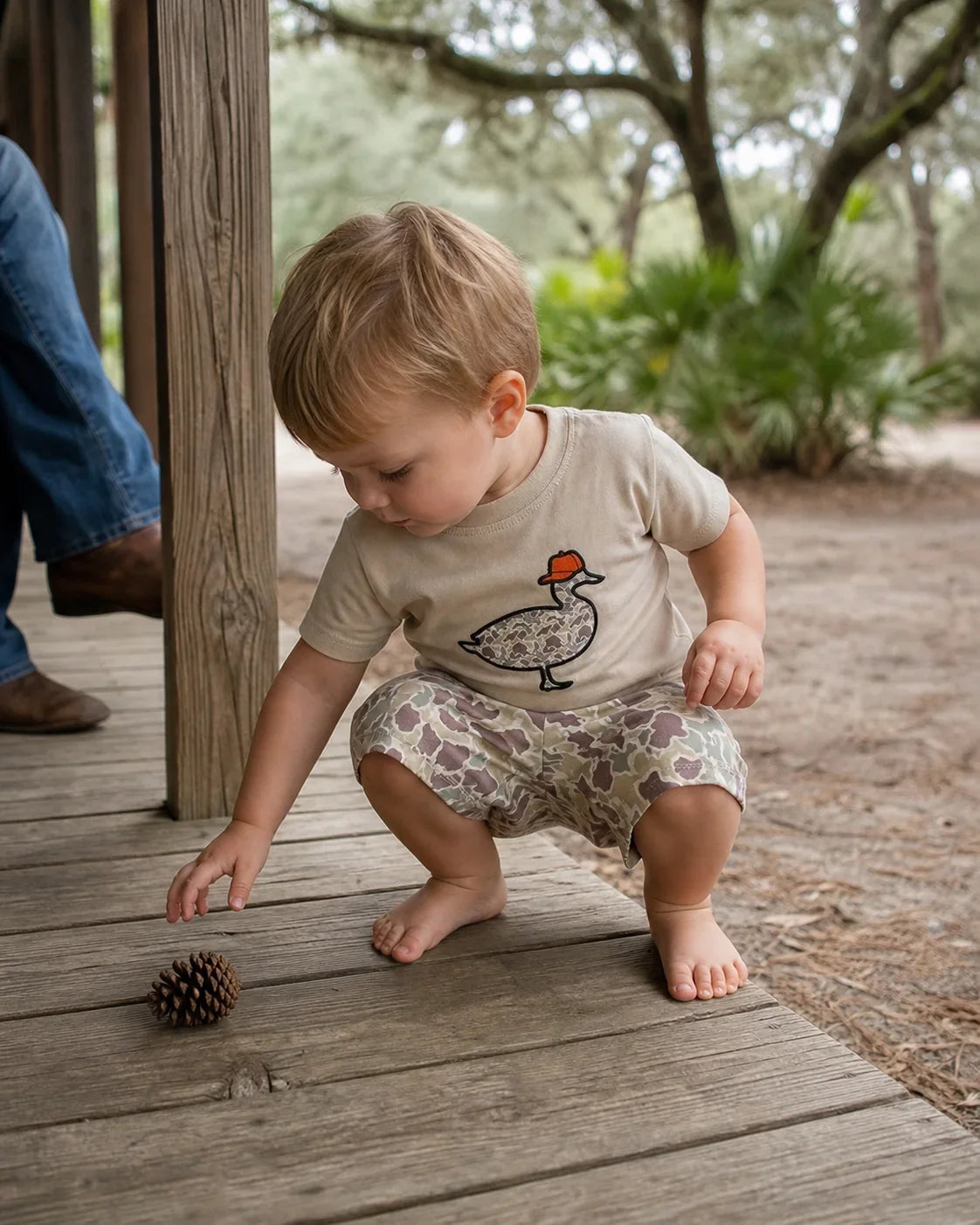 Toddler wearing a camo duck graphic shorts set on a Florida ranch