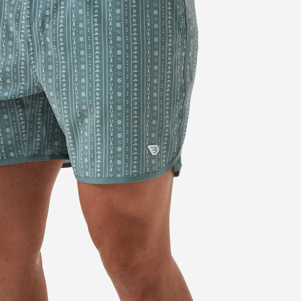 Model wearing BURLEBO Ranch Sage swim trunks