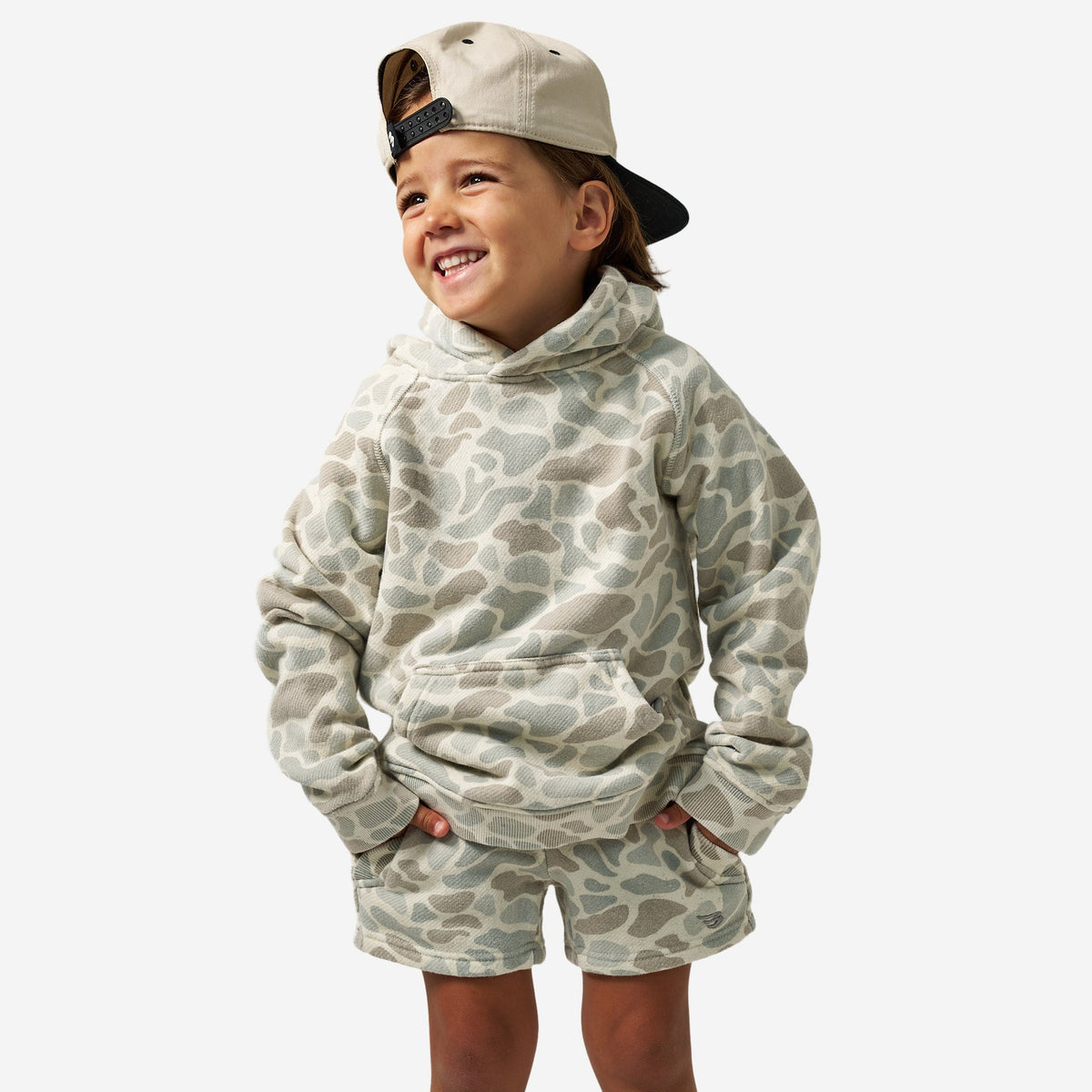 Youth wearing Classic Deer Camo hoodie with matching shorts