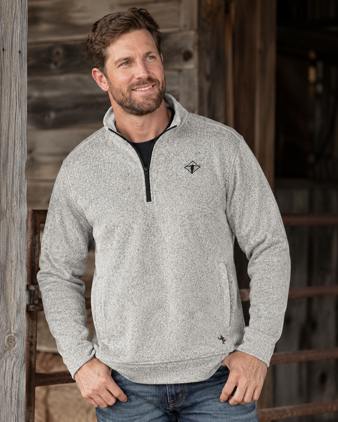 Male model wearing Cowboy Hardware quarter-zip pullover in light gray speckle